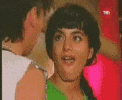 a man and a woman are standing next to each other and the woman is wearing a green top .