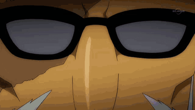 a close up of a person 's face wearing sunglasses with a tv channel in the corner