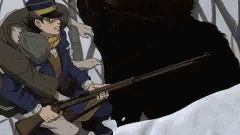 a man in a hat is holding a gun in front of a bear .