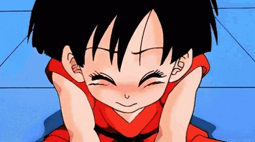 a little girl in a red shirt is making a face with her hands on her face .