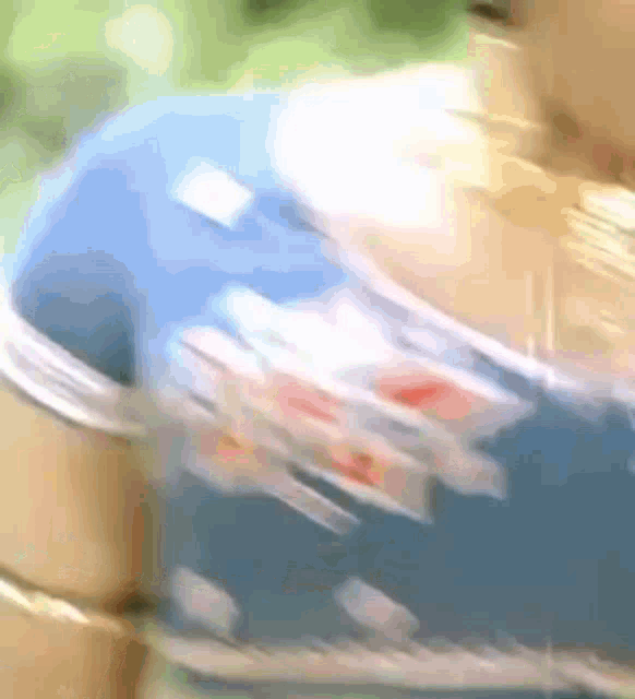 a blurry picture of a woman wearing a blue floral top
