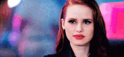a close up of a woman 's face with a blurry background .