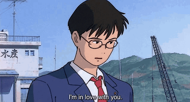 a man in a suit and tie is saying " i 'm in love with you "
