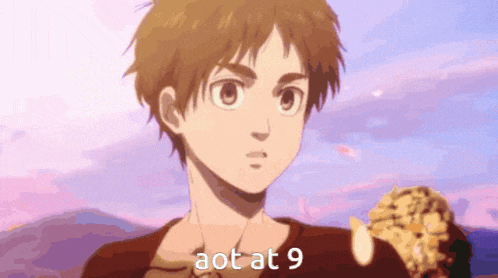 a young boy is holding a piece of food and the words aot at 9 are on the bottom of the picture .