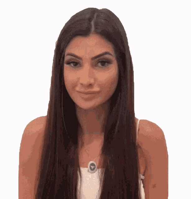 a woman with long brown hair is wearing a white tank top and a blue necklace