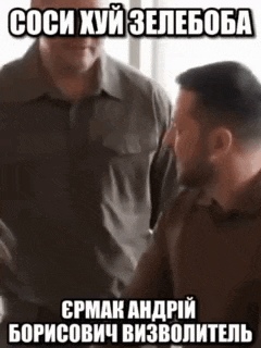 two men are standing next to each other and one of them is wearing a gray shirt .