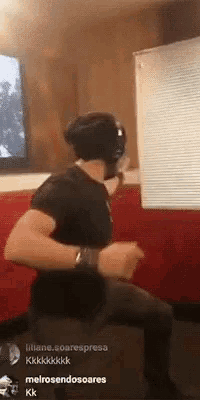a man wearing headphones is sitting on a couch in a room .