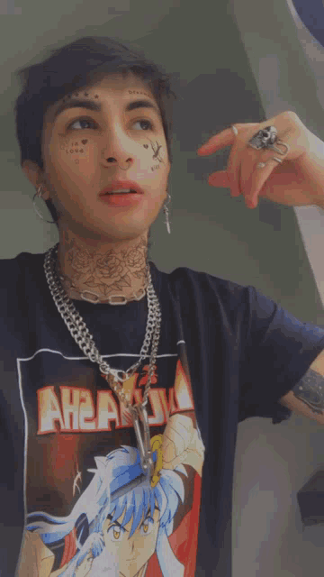 a man with a tattoo on his face is wearing a t-shirt that says ahead on it