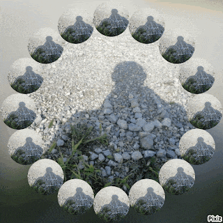 a circle of rocks with a shadow of a person on it