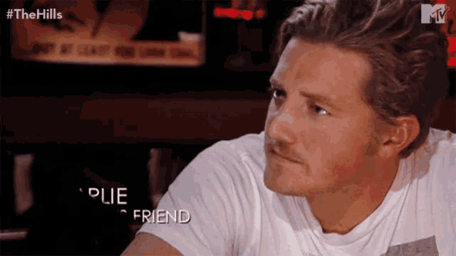a man in a white shirt with the words " plie friend " on his sleeve