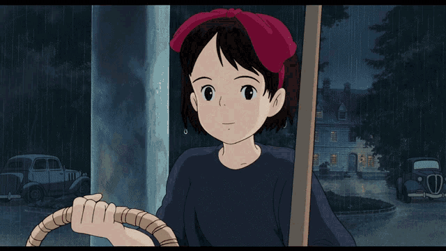a cartoon girl with a red bow on her head is holding a broom