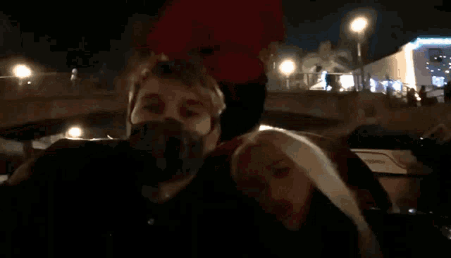 a man and a woman are laying on top of each other in a car .