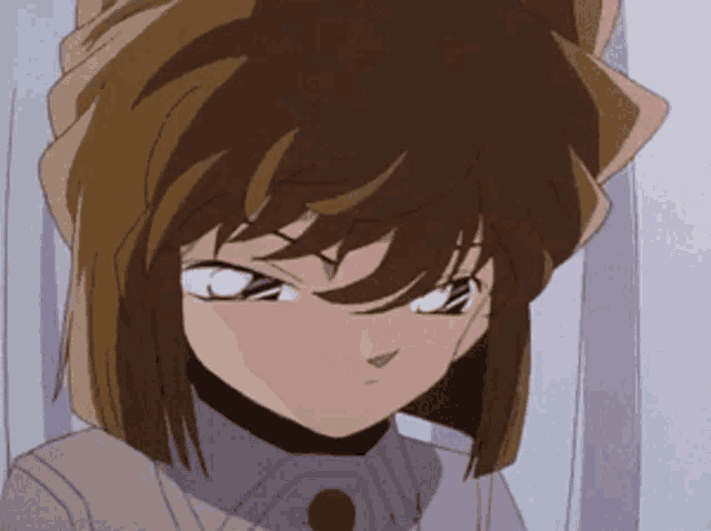 a close up of a girl 's face with a serious look on her face