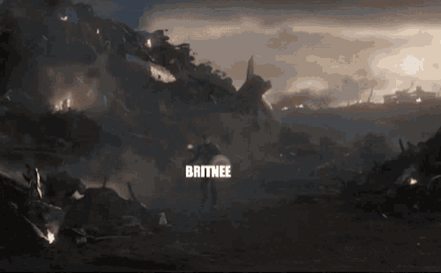 britnee is standing in the middle of a pile of rubble holding a shield