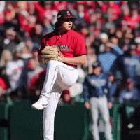 a baseball player in a red and white uniform with the word c on his hat