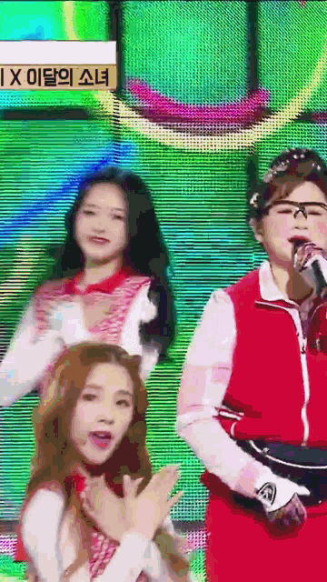 a woman in a red jacket is singing into a microphone in front of a sign that says ix