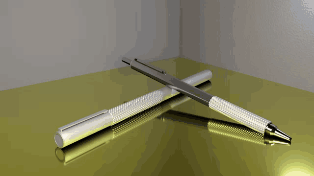 a silver pen is laying on top of another pen on a gold surface