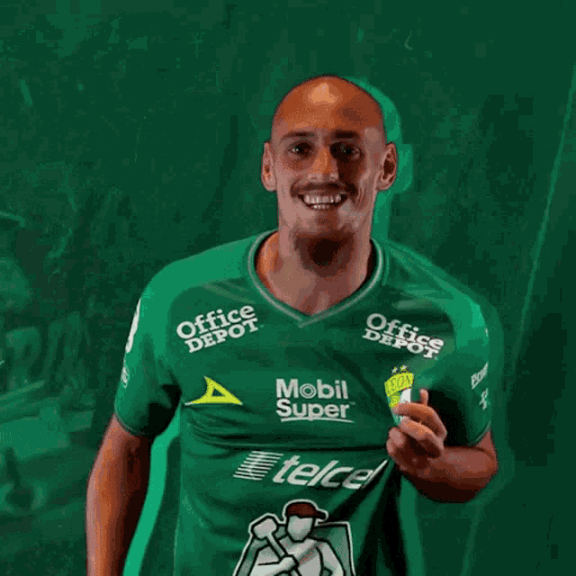 a man wearing a green jersey that says office depot