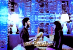 a man and woman are sitting on a bed with the words loser loser loser