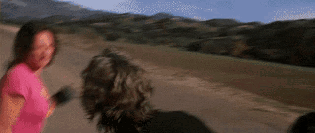a blurry picture of two people running down a road