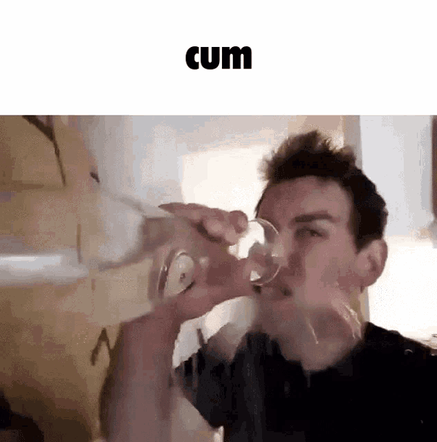 a man is drinking from a glass with the word cum written above him