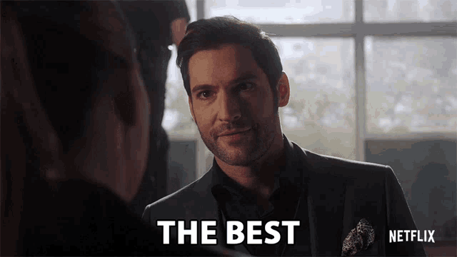 a man in a suit says " the best " in front of a woman