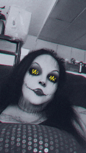 a black and white photo of a woman with a scary face and yellow eyes with the letters ok on them