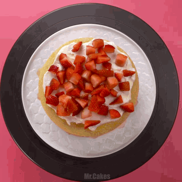 a white plate topped with strawberries and whipped cream