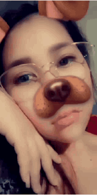 a girl with glasses and a fake dog nose on her face