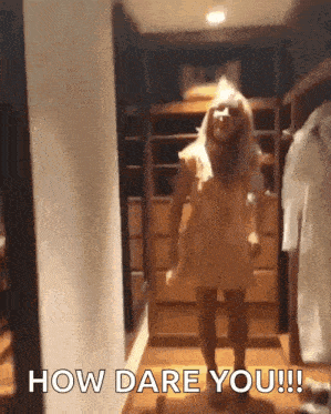 a woman in a yellow dress is dancing in a closet and says how dare you !