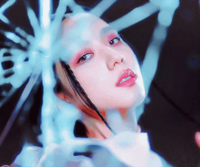 a woman 's face is reflected in a broken glass