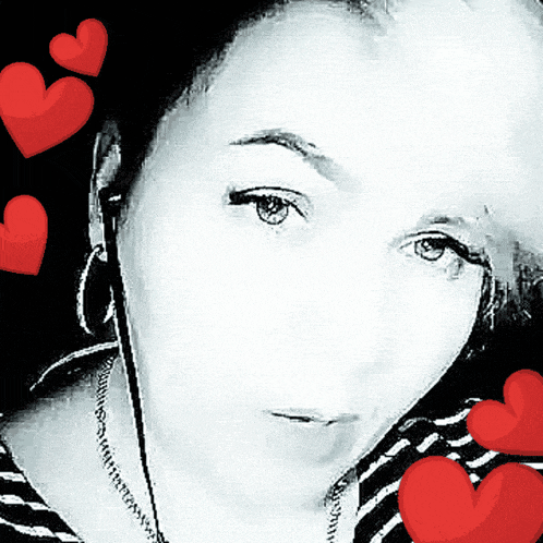 a woman 's face is surrounded by red hearts in a black and white photo