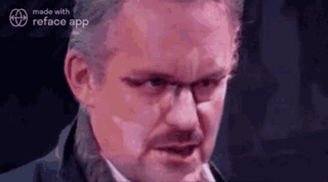 a man with glasses and a mustache is making a face .