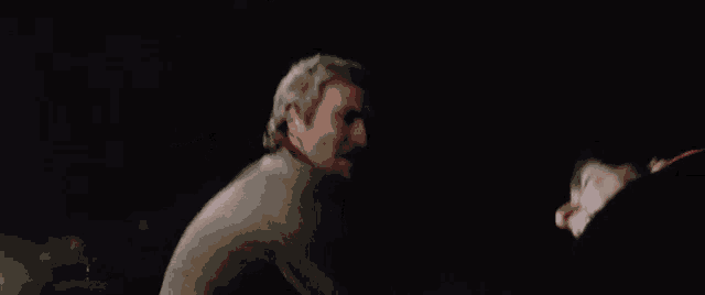 a man with his arms outstretched in the dark