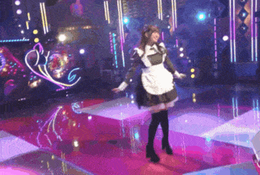 a woman in a maid costume dancing on a stage