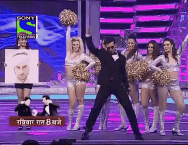 a group of cheerleaders on a stage with a sign that says sony entertainment television