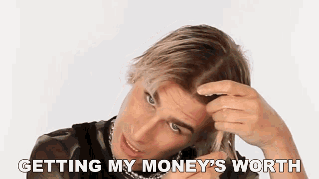 a man is getting his money 's worth while holding a dollar bill