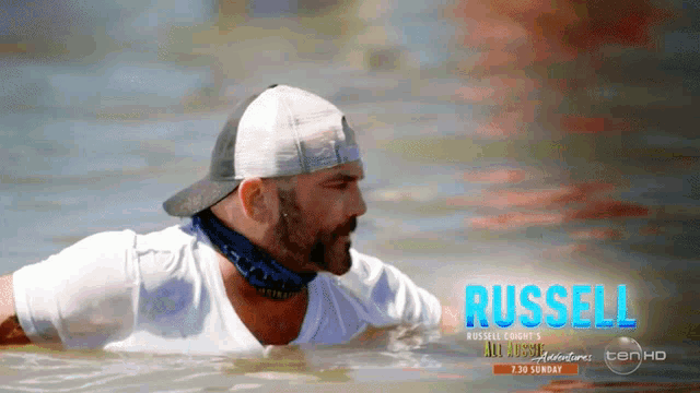 a man is swimming in the water with the name russell written on the bottom