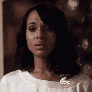 a close up of a woman 's face with a tear running down her cheek .