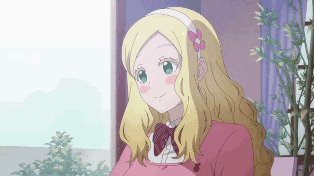 a girl with blonde hair and a headband with a pink flower on it
