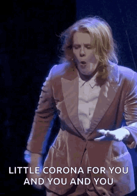 a man in a suit says " little corona for you and you and you "