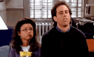 a man and a woman are sitting on a couch in a living room .