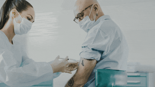 a man is getting a vaccine from a nurse and the words where serv are behind him