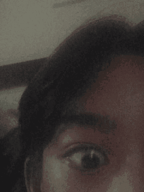a close up of a person 's face with their eyes visible