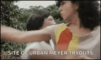 a couple of women standing next to each other with the words site of urban meyer tryouts on the bottom .