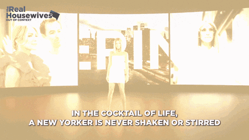 a woman stands in front of a screen that says erin