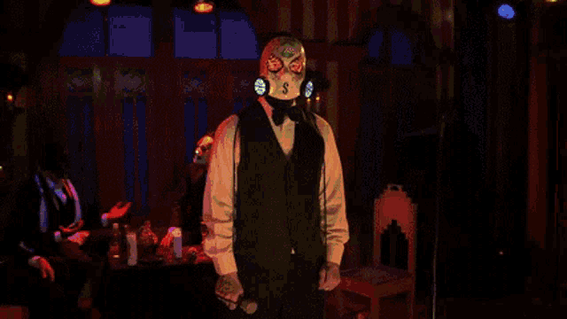 a man in a suit and tie is standing in front of a stained glass window in a dark room .