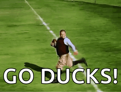 a man running on a football field with the words go ducks
