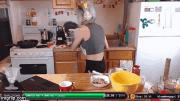 a woman wearing headphones is cooking in a kitchen with a sign that says " donations " on it