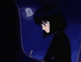a person is sitting in a dark room with a lamp on their head .